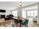 Dining area features modern table and chairs, and is open to the living room at 7111 Lillian Pl, Cumberland, IN 46229