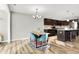 Open dining area features modern chandelier and table, and a view of the kitchen at 7111 Lillian Pl, Cumberland, IN 46229