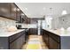 Beautiful kitchen features stainless appliances, dark cabinets, and a mosaic backsplash at 7111 Lillian Pl, Cumberland, IN 46229