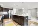 Spacious kitchen featuring a large island with a sink, stainless steel appliances, and wood-look flooring at 7111 Lillian Pl, Cumberland, IN 46229