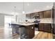 Modern kitchen featuring a central island with seating, stainless steel appliances, and stylish backsplash at 7111 Lillian Pl, Cumberland, IN 46229