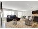 Open living area with hardwood floors, large windows, fireplace, couch, and view of dining area at 7111 Lillian Pl, Cumberland, IN 46229