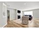Sun-filled living room with fireplace, stylish furniture, wood floors and neutral walls at 7111 Lillian Pl, Cumberland, IN 46229