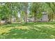 Expansive backyard with lush ground cover and mature trees, offering ample green space at 7138 Avalon Trail Ct, Indianapolis, IN 46250