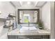 Stylish bathroom with vessel sink, floating shelves, and a large decorative mirror at 7138 Avalon Trail Ct, Indianapolis, IN 46250
