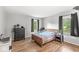 Bedroom with hardwood floors, two windows, and a dark dresser at 7138 Avalon Trail Ct, Indianapolis, IN 46250