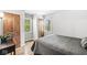Cozy bedroom with hardwood floors, closet, and natural light from the window overlooking the outside greenery at 7138 Avalon Trail Ct, Indianapolis, IN 46250