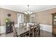 Traditional dining room with a dark wood table, chandelier, and access to the staircase at 7138 Avalon Trail Ct, Indianapolis, IN 46250