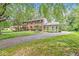 Traditional two-story brick home featuring mature trees and long driveway at 7138 Avalon Trail Ct, Indianapolis, IN 46250