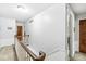 Upstairs hallway with white walls, wood railing and trim, and carpeted floors at 7138 Avalon Trail Ct, Indianapolis, IN 46250