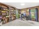 A spacious office features custom wood built-ins, large windows, and a comfortable workspace at 7138 Avalon Trail Ct, Indianapolis, IN 46250