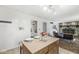 The kitchen island extends into living area with a stone fireplace creating an inviting floor plan at 7138 Avalon Trail Ct, Indianapolis, IN 46250
