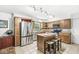 Bright kitchen features stainless steel appliances, granite countertops, and a center island at 7138 Avalon Trail Ct, Indianapolis, IN 46250