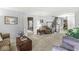 Spacious living room with neutral carpeting, comfortable seating, and stairway view at 7138 Avalon Trail Ct, Indianapolis, IN 46250