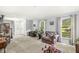 Airy living room with neutral carpet, traditional stairway, and natural light at 7138 Avalon Trail Ct, Indianapolis, IN 46250