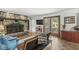 Spacious living room with a stone fireplace, glass doors to the outside, and comfortable seating at 7138 Avalon Trail Ct, Indianapolis, IN 46250