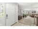 Bright living room with neutral carpet, stylish furniture, and decorative front door at 7138 Avalon Trail Ct, Indianapolis, IN 46250