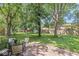 Outdoor patio with glass-top table and chairs, perfect for relaxing in the shade of mature trees at 7138 Avalon Trail Ct, Indianapolis, IN 46250