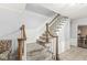 Carpeted staircase with wooden railing and white trim leading to the upper level of the home at 7138 Avalon Trail Ct, Indianapolis, IN 46250