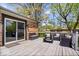 Outdoor deck with sliding glass door, black metal furniture, and a relaxing space for entertaining and enjoying the outdoors at 7263 Hidden Valley Dr, Plainfield, IN 46168