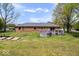 View of the home's backyard with a wood deck, lawn, and mature trees offering serene outdoor living at 7263 Hidden Valley Dr, Plainfield, IN 46168