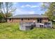 Home's backyard with wooden deck and brick house, showcasing a tranquil outdoor setting at 7263 Hidden Valley Dr, Plainfield, IN 46168