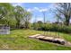 Grassy backyard featuring a wooden deck, garden beds, and ample green space at 7263 Hidden Valley Dr, Plainfield, IN 46168