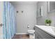 Cozy bathroom featuring a blue shower curtain, decor, and a modern vanity for ample storage and style at 7263 Hidden Valley Dr, Plainfield, IN 46168