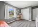 Gray-walled bedroom with plush carpet, a sunny window, and convenient closet space for storage solutions at 7263 Hidden Valley Dr, Plainfield, IN 46168