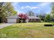 Traditional brick home with an attached garage, mature trees, and a green lawn in a well-maintained neighborhood at 7263 Hidden Valley Dr, Plainfield, IN 46168