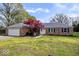 Charming brick home featuring a well-manicured lawn, beautiful landscaping, and an attached two-car garage at 7263 Hidden Valley Dr, Plainfield, IN 46168