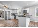 The kitchen has stainless appliances, white cabinets, and a breakfast bar overlooking the living area at 7263 Hidden Valley Dr, Plainfield, IN 46168