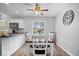 Eat-in kitchen features white cabinets and stainless appliances with a view to the dining area at 7263 Hidden Valley Dr, Plainfield, IN 46168