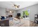 Open-concept living room with a cozy fireplace, modern furniture, and sliding glass doors to the outdoor deck at 7263 Hidden Valley Dr, Plainfield, IN 46168