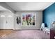 Bright, carpeted living room featuring front door, large windows, and adjacent ' play area at 7263 Hidden Valley Dr, Plainfield, IN 46168