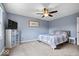 Bedroom with blue walls, carpet flooring, ceiling fan, tv, and natural light through the window at 7263 Hidden Valley Dr, Plainfield, IN 46168