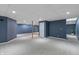 Unfinished basement with blue walls, neutral carpeting, and potential for customization at 8259 Plumwood Ln, Indianapolis, IN 46256