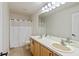 Well-lit bathroom with a double sink vanity, a large mirror, and a shower with a white curtain at 8259 Plumwood Ln, Indianapolis, IN 46256