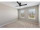 Inviting bedroom with neutral walls, soft carpet, and two windows offering plenty of natural light at 8259 Plumwood Ln, Indianapolis, IN 46256