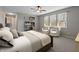 Cozy bedroom with a ceiling fan, a bookcase, and two inviting chairs at 8259 Plumwood Ln, Indianapolis, IN 46256