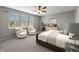 Comfortable bedroom with large windows and two inviting chairs with cushions at 8259 Plumwood Ln, Indianapolis, IN 46256