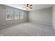 Large, empty bedroom featuring plush carpeting and large windows at 8259 Plumwood Ln, Indianapolis, IN 46256