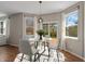 Cozy dining area with a glass table, comfortable seating, and sliding glass doors to the deck at 8259 Plumwood Ln, Indianapolis, IN 46256