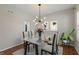 Modern dining room featuring contemporary light fixture and glass top dining table at 8259 Plumwood Ln, Indianapolis, IN 46256