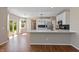 Modern kitchen with white cabinets, stainless steel appliances, and a breakfast bar at 8259 Plumwood Ln, Indianapolis, IN 46256