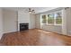Inviting living room with a fireplace, hardwood floors, and large windows at 8259 Plumwood Ln, Indianapolis, IN 46256