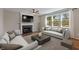 Bright living room with a fireplace, hardwood floors, and comfortable seating at 8259 Plumwood Ln, Indianapolis, IN 46256