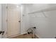 Mud room area featuring door, shelving, and hookups for laundry machines at 8259 Plumwood Ln, Indianapolis, IN 46256