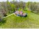 Aerial view showcases a sprawling green lawn, manicured landscape with mature trees enhancing the home's curb appeal at 8654 N Baltimore Rd, Monrovia, IN 46157