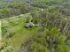 Aerial view of the property featuring a home nestled among trees at 8654 N Baltimore Rd, Monrovia, IN 46157